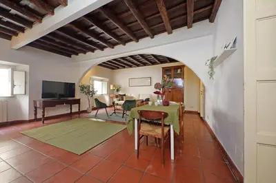 a living room with a table and a piano at Cozy Apartment Rione Monti in Rome