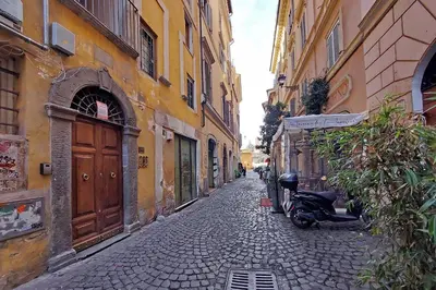 a cobblestone alley with a scooter parked on a street at Cozy Apartment Rione Monti in Rome