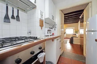 a kitchen with a stove and a stove top oven at Cozy Apartment Rione Monti in Rome