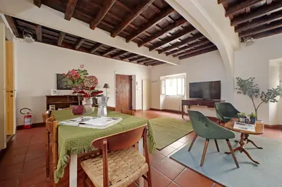 a living room with a green table and chairs at Cozy Apartment Rione Monti in Rome
