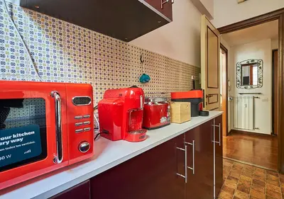 a kitchen with a red appliance on a counter at Crimson Guest House in Rome