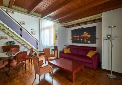 a living room with a red couch and a table at Crimson Guest House in Rome