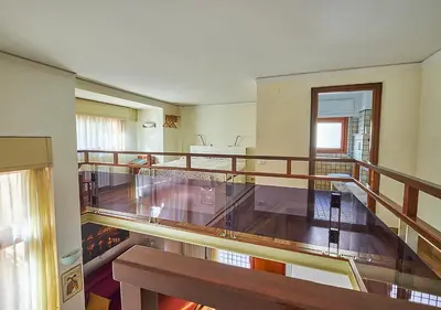 an empty room with a balcony with a wooden staircase at Crimson Guest House in Rome