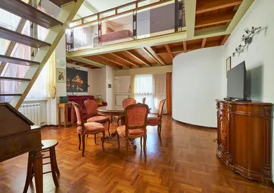 a living room with a table and chairs and a television at Crimson Guest House in Rome