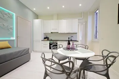 a kitchen and dining room with a table and chairs at Domus Augustea - San Giovanni Sunset Suites in Rome