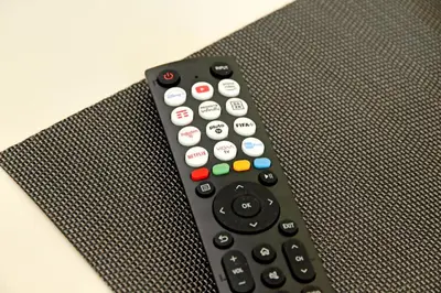 a remote control sitting on top of a chair at Domus Augustea - San Giovanni Sunset Suites in Rome