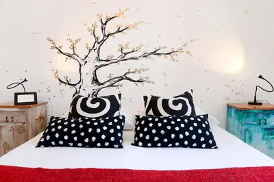 a bedroom with a bed with black and white pillows at Bella Nonna in Rome