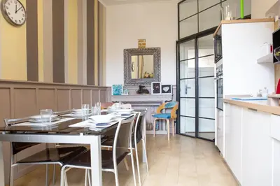 a kitchen with a table and chairs in a room at Art Apartment in Rome