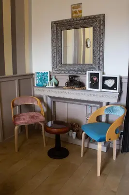a dining room with a table and chairs and a clock at Art Apartment in Rome