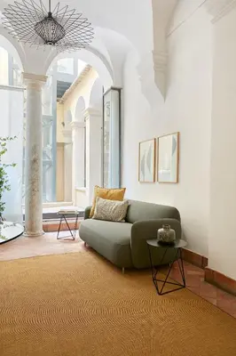 a living room with a green couch and a table at Montevecchio Boutique Apartments in Rome