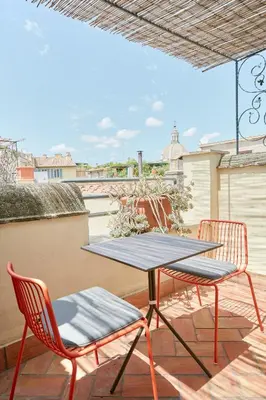 a table and two chairs on a patio at Montevecchio Boutique Apartments in Rome