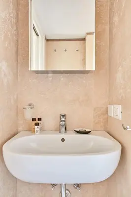 a white sink in a bathroom with a mirror at Montevecchio Boutique Apartments in Rome