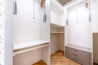 a walk in closet with white cabinets and a window at Bellina Suite Hi Tech Apartment in Rome