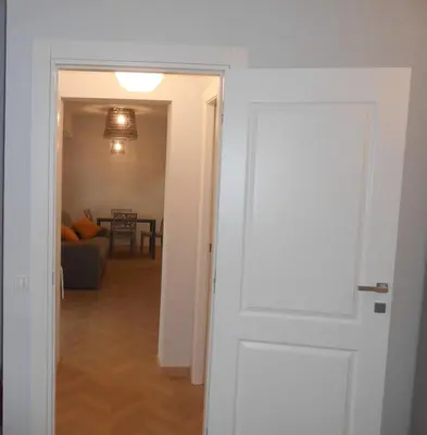 a door leading into a living room with a couch at Via Cipro in Rome