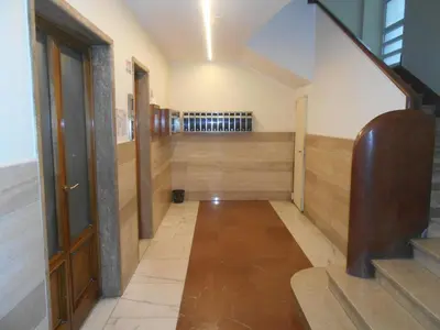 an empty hallway with stairs and a door at Via Cipro in Rome