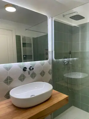 a bathroom with a white sink and a shower at Bed & Breakfast RCH Roman Central House in Rome