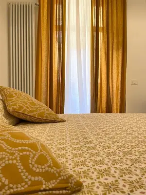 a bed with a comforter and pillows on it at Bed & Breakfast RCH Roman Central House in Rome
