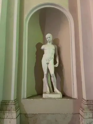 a statue of a man standing on a wall at Bed & Breakfast RCH Roman Central House in Rome