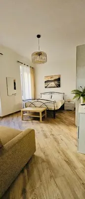 a large bedroom with a bed and a couch at La casa di Tilde Roma Angelino in Rome