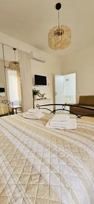 a large bedroom with two beds and a television at La casa di Tilde Roma Angelino in Rome