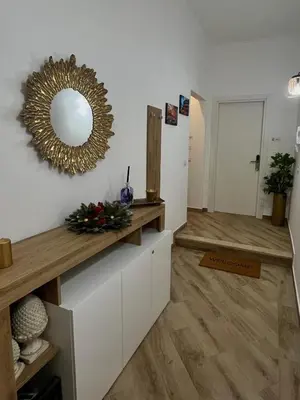a living room with a mirror on the wall at La casa di Tilde Roma Angelino in Rome