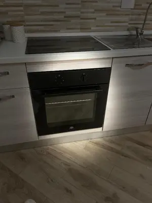 a kitchen with a black oven in a counter at La casa di Tilde Roma Angelino in Rome
