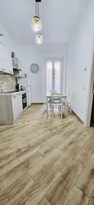 a living room with a table and a kitchen at La casa di Tilde Roma Angelino in Rome