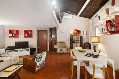 a bedroom with a white bed and a wooden ceiling at Trastevere Lovely Apartment in Rome