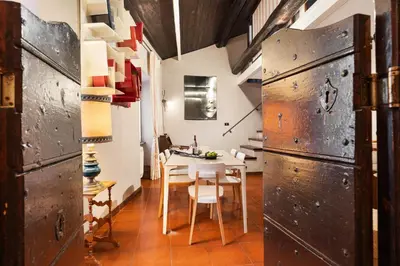 a dining room and living room with a table and chairs at Trastevere Lovely Apartment in Rome