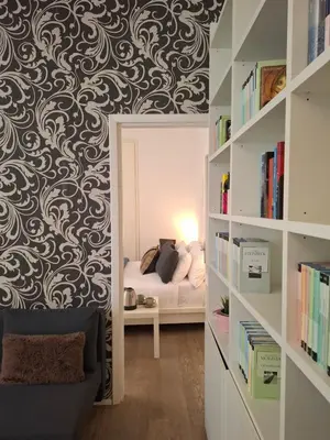 a bedroom with a bed and a book shelf at Casetta Vaticano in Rome