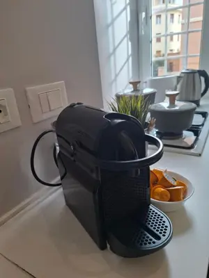 a coffee maker on a counter with a bowl of oranges at Casetta Vaticano in Rome