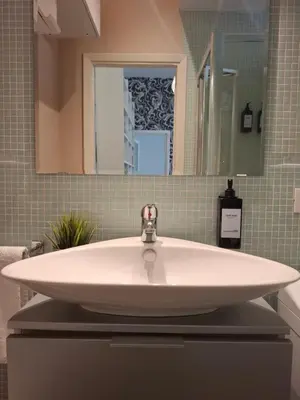 a white sink in a bathroom with a mirror at Casetta Vaticano in Rome