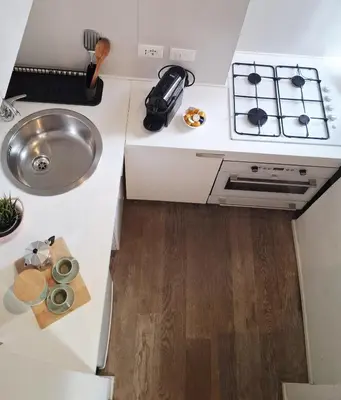 a small kitchen with a sink and a stove at Casetta Vaticano in Rome
