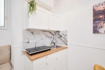 a kitchen with white cabinets and a sink at 5 minutes from the Vatican - Elegant flat - Wi-Fi in Rome