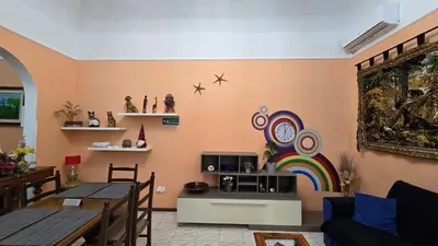 a living room with a table and a rainbow on the wall at BnB Rooms And Comfort in Rome