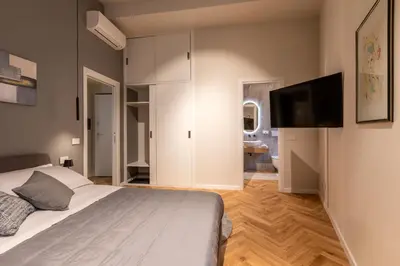 a bedroom with a bed and a flat screen tv at Vatican Charming RHome in Rome