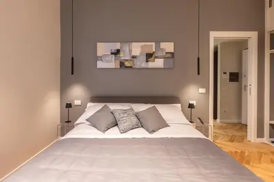 a bedroom with a large white bed with three pillows at Vatican Charming RHome in Rome