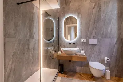 a bathroom with a sink and two mirrors at Vatican Charming RHome in Rome