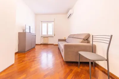 a living room with a couch and a chair at Easy Host Apt Casa Numitore in Rome