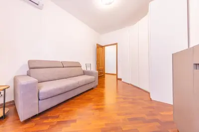 a living room with a couch and a wooden floor at Easy Host Apt Casa Numitore in Rome
