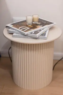 a table with two candles and magazines on it at Trionfale Home in Rome