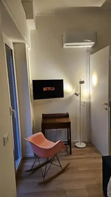 a living room with a chair and a desk at Trionfale Home in Rome