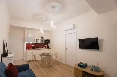a living room with a blue couch and a table at Trionfale Home in Rome