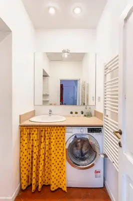 a washing machine in a kitchen with a sink at Maison Colosseo in Rome
