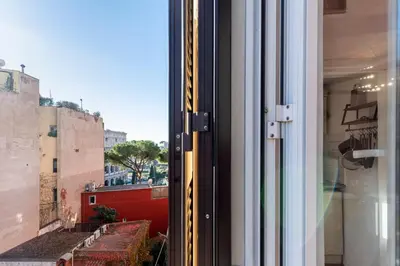 a window with a view of a city at Maison Colosseo in Rome