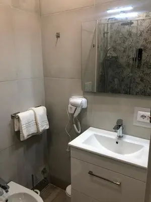 a bathroom with a sink and a toilet and a mirror at B&B Rome Vatican Residence in Rome