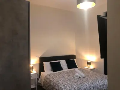 a bedroom with a bed with black and white pillows at B&B Rome Vatican Residence in Rome