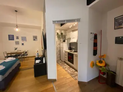 a room with a kitchen and a living room at LaCasitaDeAU - Trastevere-Monteverde-Vaticano in Rome