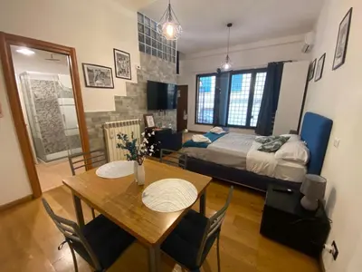 a room with a table and a bed and a bedroom at LaCasitaDeAU - Trastevere-Monteverde-Vaticano in Rome