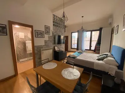 a bedroom with a bed and a table and chairs at LaCasitaDeAU - Trastevere-Monteverde-Vaticano in Rome